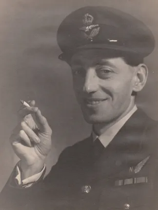 Arthur White in uniform, smiling and holding a cigarette