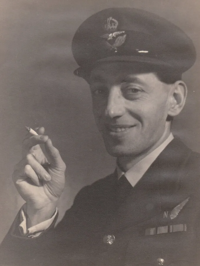 Arthur White in uniform, smiling and holding a cigarette