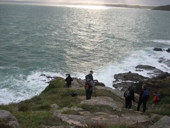Walkers crossing the rugged Brittany coast