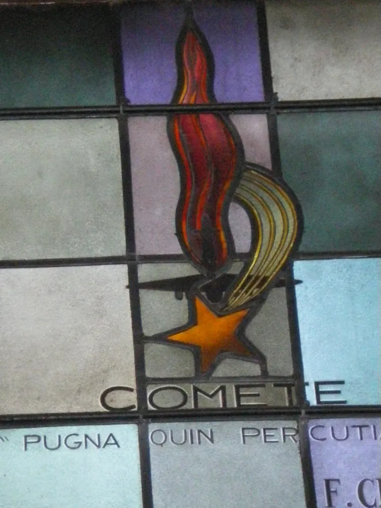 Comète badge in a stained-glass memorial window