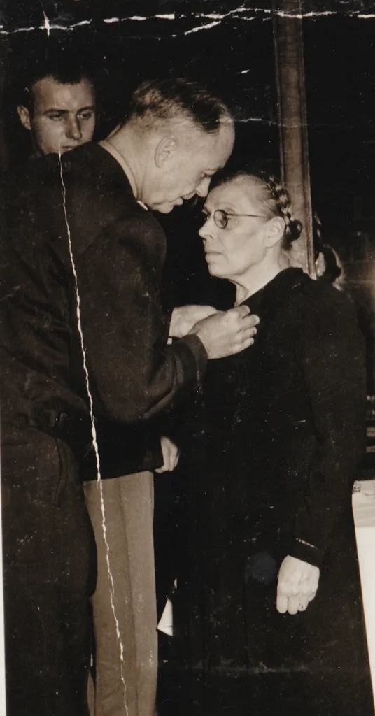 Marie-Louise Dissard receiving a decoration