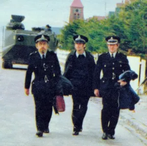 Fred Clark, left, with fellow Stanley police officers after the liberation of the islands