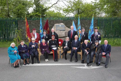 ELMS members gathered around the Memorial to the Helpers