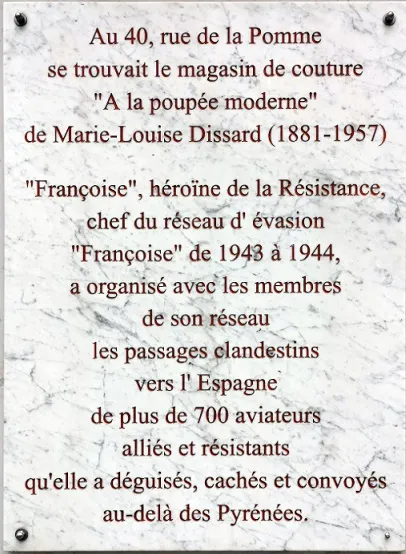 Plaque at Marie-Louise Dissard's former shop on rue de la Pomme