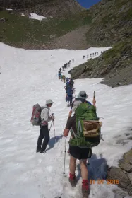 Le Chemin walkers crossing a field of snow