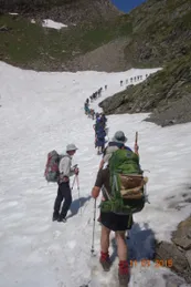 Walkers crossing a snow field on the Chemin de la Liberte